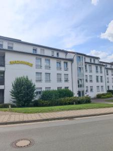 a large white building with a sign on it at Hotel Akazienhaus in Herzogenaurach