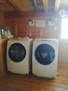 two washing machines sitting next to each other in a room at Naoshima Accommodation Menjuku Ura - Vacation STAY 92589v in Naoshima +2 photos