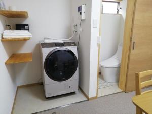 a bathroom with a washing machine and a toilet at Naoshima Accommodation Menjuku Ura - Vacation STAY 25944v in Naoshima