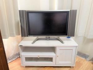 a tv on a white stand with a tv at Shibasaki House 1F - Vacation STAY 13848 in Kusatsu +8 photos