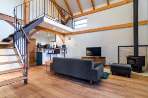 a living room with a couch and a staircase at TOOD Ichinomiya - Vacation STAY 97261v in Ichinomiya