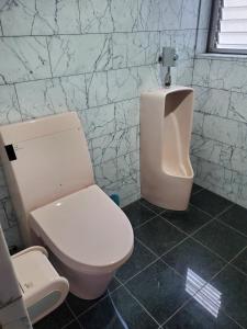 a bathroom with a white toilet and a sink at Curfew by midnight Guesthouse Tosa Hanare - Vacation STAY 14262 in Kochi
