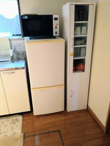a white refrigerator with a microwave on top of it at Kagawagun - House - Vacation STAY 01716v in Naoshima