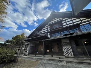 un vieux bâtiment japonais sous un ciel bleu dans l'établissement Satoyama Villa Honjin - Vacation STAY 17842, à Matsumoto