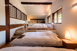 two beds in a room with a bunk bed at Satoyama villa DEN - Vacation STAY 17844 in Matsumoto +10 photos