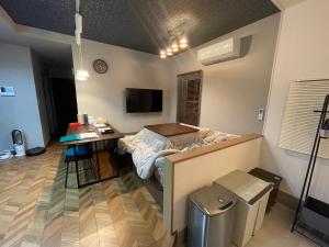 a room with a bed and a desk in it at Guest House Numazu Port - Vacation STAY 18050v in Numazu