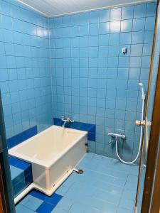 a blue tiled bathroom with a bath tub at FUKUINN - Vacation STAY 19245v in Takamatsu