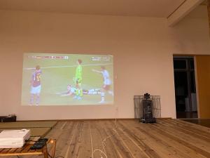 a projection screen on a wall with people playing soccer at Nagatanchi - Vacation STAY 19913v in Mimata