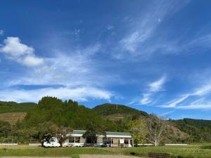 a house in front of a hill with a blue sky at Nagatanchi - Vacation STAY 19913v in Mimata
