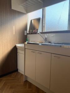 a bathroom with a sink and a mirror at guest house goose - Vacation STAY 21037v in Hirosaki