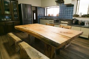 a large wooden table in a kitchen with chairs at VillageOMOYA - Vacation STAY 24662v in Ina +8 photos