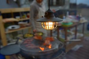 a light hanging over a table with a fire at VillageOMOYA - Vacation STAY 24662v in Ina