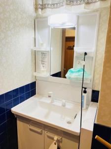 a bathroom with a white sink and a mirror at FUKUINN - Vacation STAY 19238v in Takamatsu