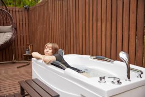 a little girl laying in a bath tub at TinyCabinTATEGU#02 - Vacation STAY 20575v in Oiwake +85 photos