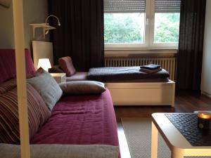 a living room with a couch and a window at HertenFlats - Rooms & Apartments - Kreis Recklinghausen in Herten