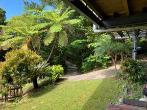 a garden with a bench and trees and a pathway at Inn Suenaga - Vacation STAY 25965v in Hiji