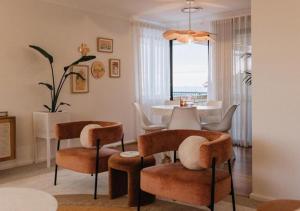 a living room with a table and some chairs at Dolce Vista - North Beach Coastal Haven in Perth