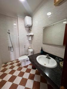 a bathroom with a sink and a toilet and a mirror at Sao Mai in Hai Phong