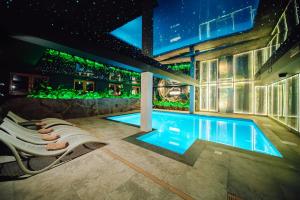 a house with a swimming pool at night at Hotel Le Mont Medical & SPA Adults Only in Świeradów-Zdrój