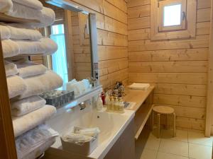 a bathroom with a stack of towels on a counter at Polar House Karuisawa - Vacation STAY 30319v in Kutsukake +20 photos