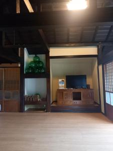 a living room with a tv and a entertainment center at Amami - House - Vacation STAY 35269v in Amami +4 photos