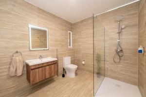 a bathroom with a toilet and a sink and a shower at Luxury Apartment Valley Views C5 in Xagħra +32 photos