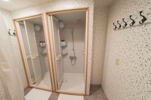 a shower in a bathroom with a glass door at Business Hotel Kankokukan - Vacation STAY 45949v in Tokyo