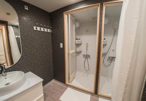 a bathroom with a shower and a sink at Business Hotel Kankokukan - Vacation STAY 45949v in Tokyo