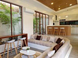a living room with a couch and a kitchen at Balay Vicente in Tarlac