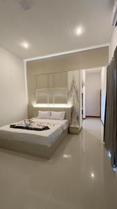 a bedroom with a large bed in a room at Bukit Langit Campventure in Glagah
