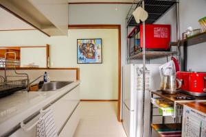 a kitchen with a sink and a refrigerator at Twilight Villa Onjuku - Vacation STAY 52776v in Iwada