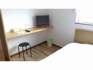 a room with a desk with a monitor and a stool at Minshuku Cress - Vacation STAY 48561v in Biei
