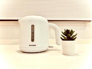 a white toaster sitting next to a potted plant at Marina HOUSE Onjuku - Vacation STAY 14125 in Iwada