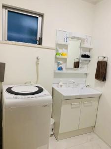 a small bathroom with a sink and a washing machine at Maisonette Hanazono - Vacation STAY 63319v in Kemigawa-machi +24 photos