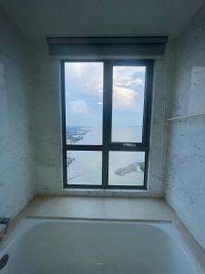 a bath tub in a room with a window at 2 Bedrooms Seaview Apartment in Silverscape Residence in Malacca +5 photos