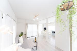 a white living room with a white couch and a table at Yokkaichi City - House - Vacation STAY 68977v in Nishi-hino