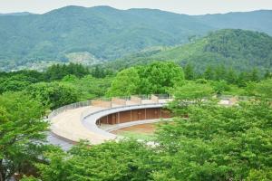 a building in the middle of a forest with mountains at hanaya satoyama - Vacation STAY 72033v in Ishioka