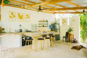 a kitchen with a wooden table and chairs in a room at Yay Lodge SIARGAO, private room 1 with AC & hot shower and fast Starlink Wifi in General Luna