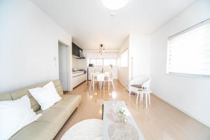 a living room with a couch and a table at Yokkaichi - House - Vacation STAY 68949v in Yokkaichi