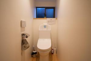 a bathroom with a toilet in a room with a window at Kashi house - Vacation STAY 14251 in Kai
