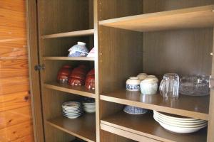a cupboard filled with dishes and bowls and plates at Washinosu Campground - Vacation STAY 85295v in Motegi