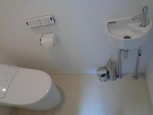 a bathroom with a toilet and a sink at SENKO TINY CAMP - Vacation STAY 34705v in Ueda