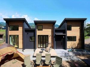 a house with a table and chairs in front of it at SENKO TINY CAMP - Vacation STAY 34705v in Ueda +5 photos