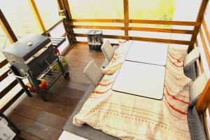a small room with a table and a grill at Glamping nijo in Itoshima - Vacation STAY 71943v in Itoshima
