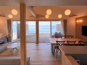 a living room with a table and a view of the ocean at Beach SPA TSUDA 2&3 - Vacation STAY 76520v in Sanuki