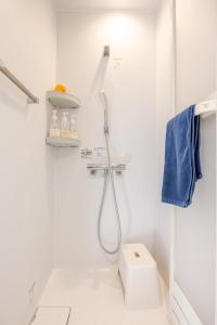 a white bathroom with a shower and a toilet at Turf and Surf Taito Beach - Vacation STAY 76598v in Isumi