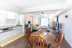 a kitchen and dining room with a table and chairs at VIVI Atami Shizenkyo Room 3001 - Vacation STAY 14277 in Atami
