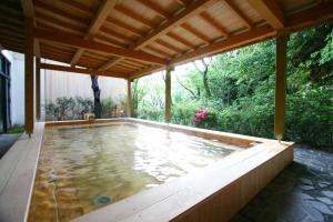 an outdoor pool with a wooden pergola at VIVI Atami Shizenkyo Room 3001 - Vacation STAY 14277 in Atami