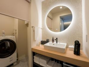 a bathroom with a sink and a mirror at Rakuten STAY VILLA Yatsugatake - 108 Simple Modern Pets Friendly - in Hokuto