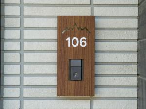 a wooden door with the number on a wall at Rakuten STAY VILLA Yatsugatake - 106 Family Room - in Hokuto